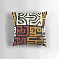 African-inspired mudcloth design throw pillow in black, white, and metallic gold tones
