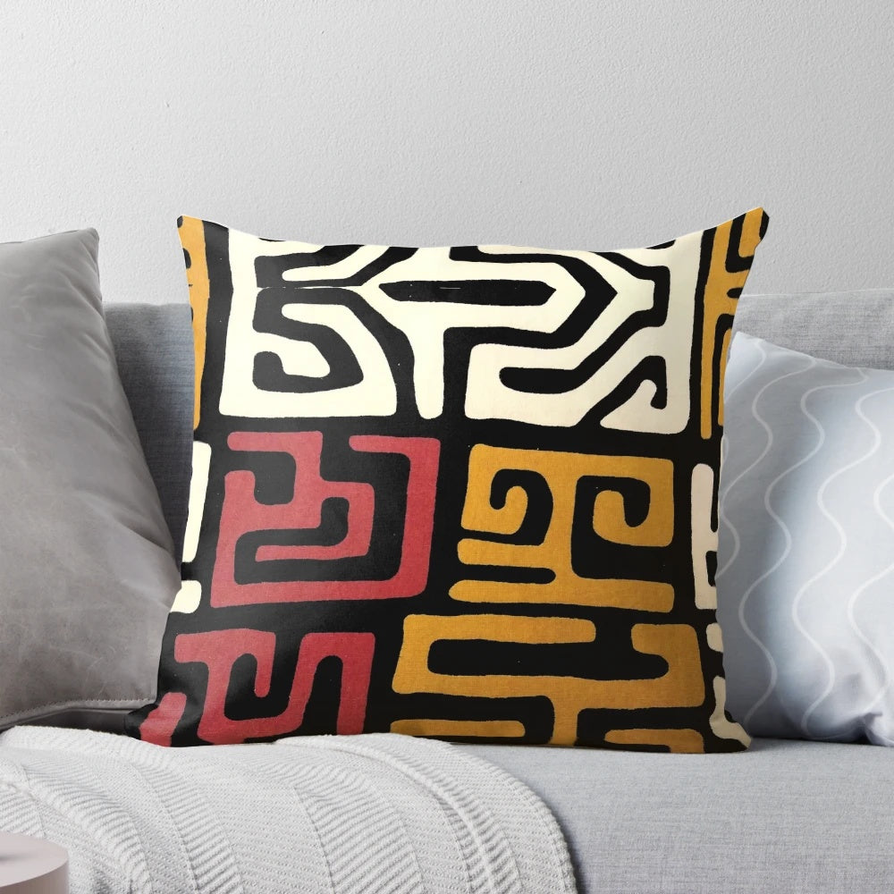 African-inspired mudcloth design throw pillow in black, white, and metallic gold tones