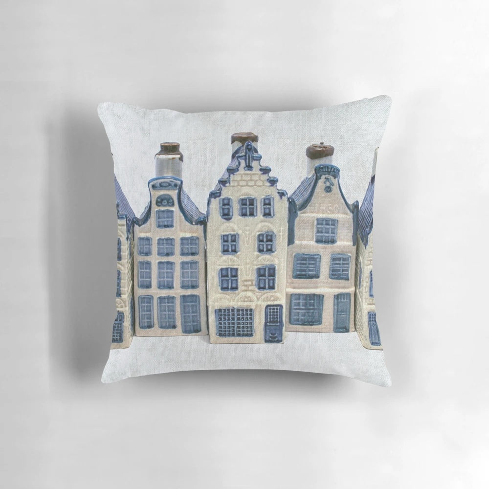Delft blue and white decorative pillow with classic Dutch canal house design