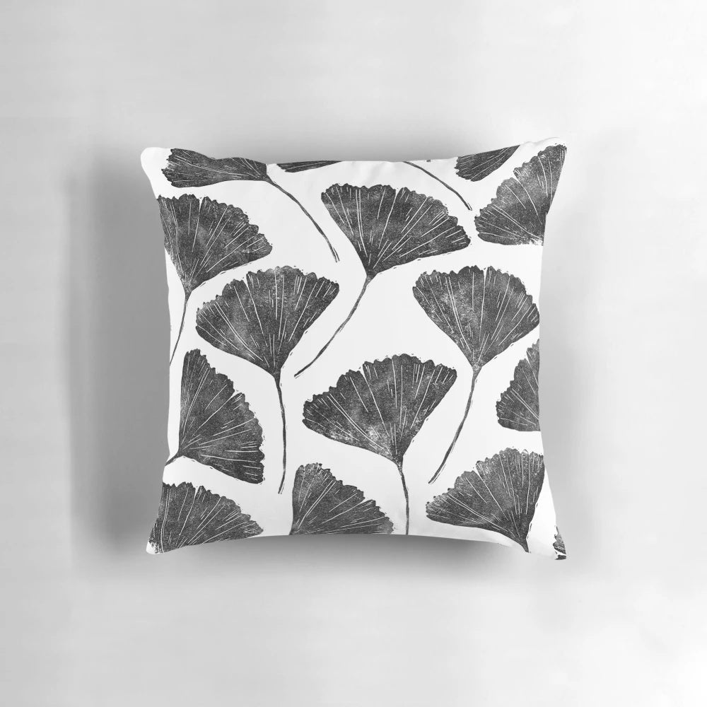 Handmade linocut pillow featuring a nature-inspired black and white leaf pattern design