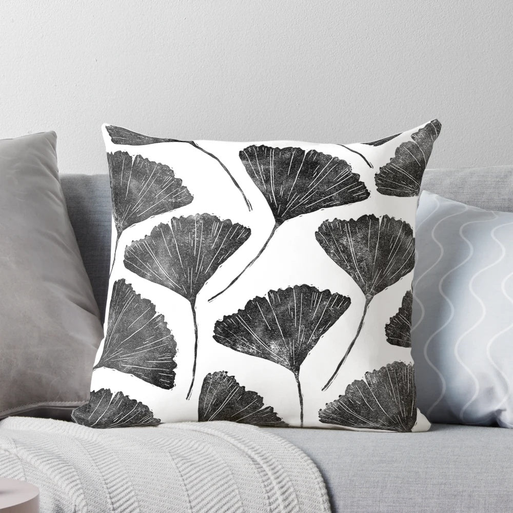 Handmade linocut pillow featuring a nature-inspired black and white leaf pattern design