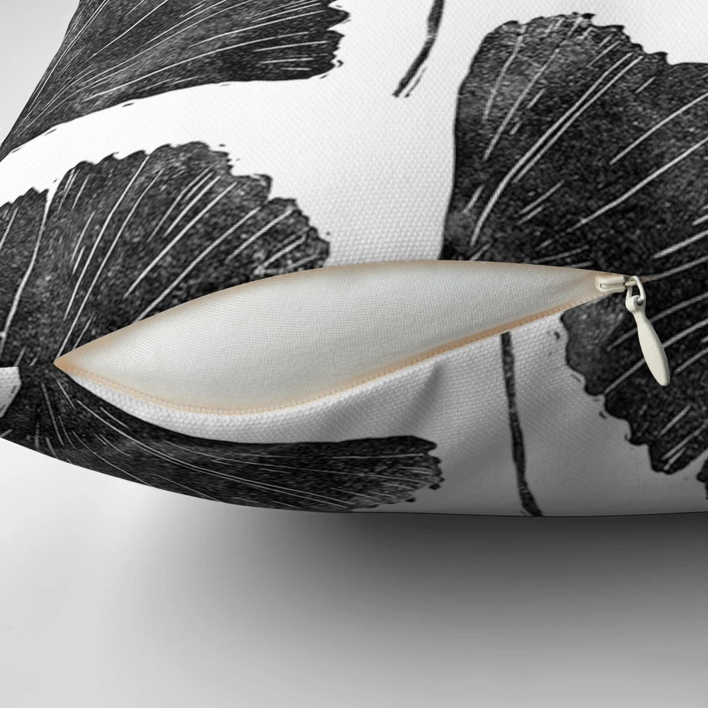 Handmade linocut pillow featuring a nature-inspired black and white leaf pattern design