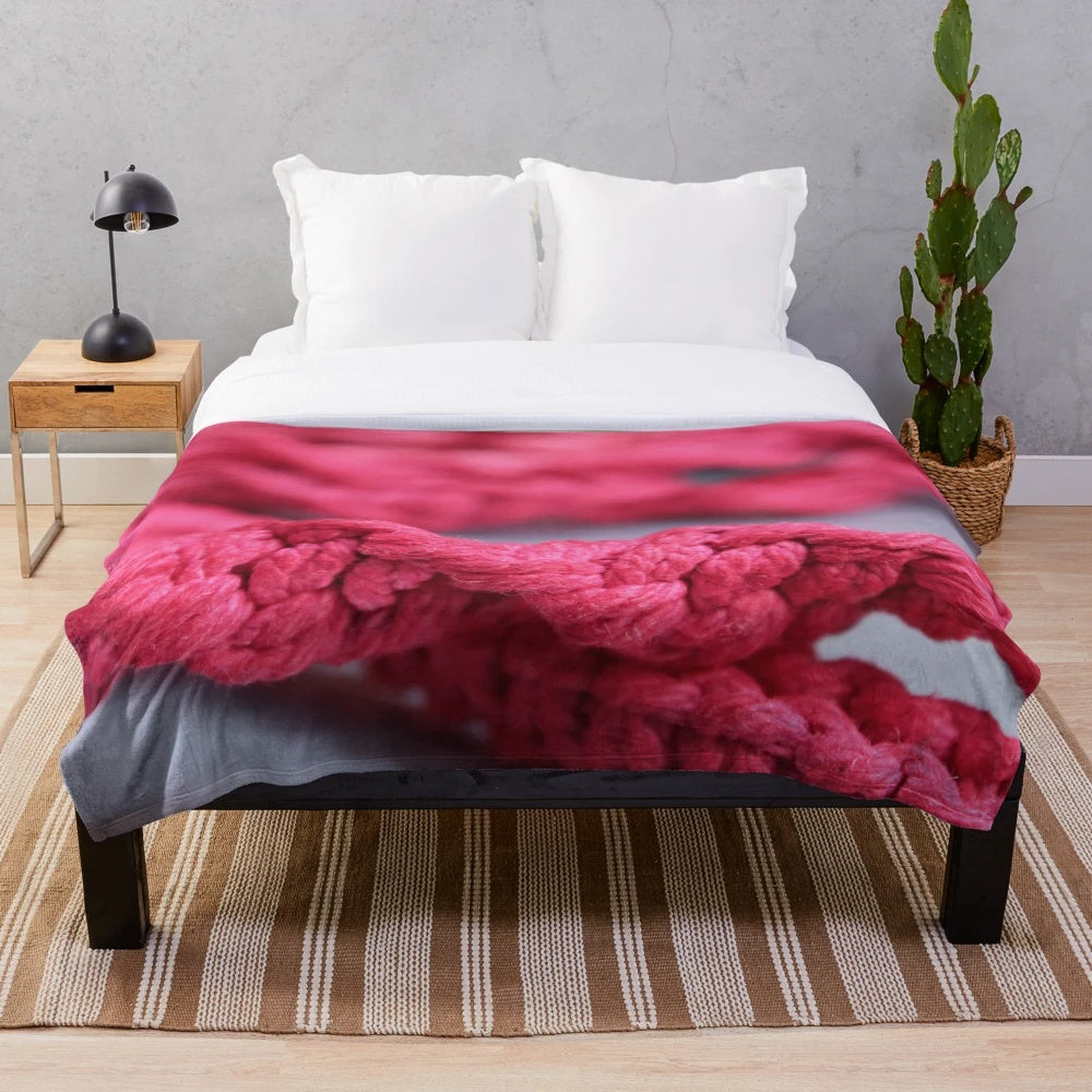 Handmade macrame plush blanket in soft pink and red colors