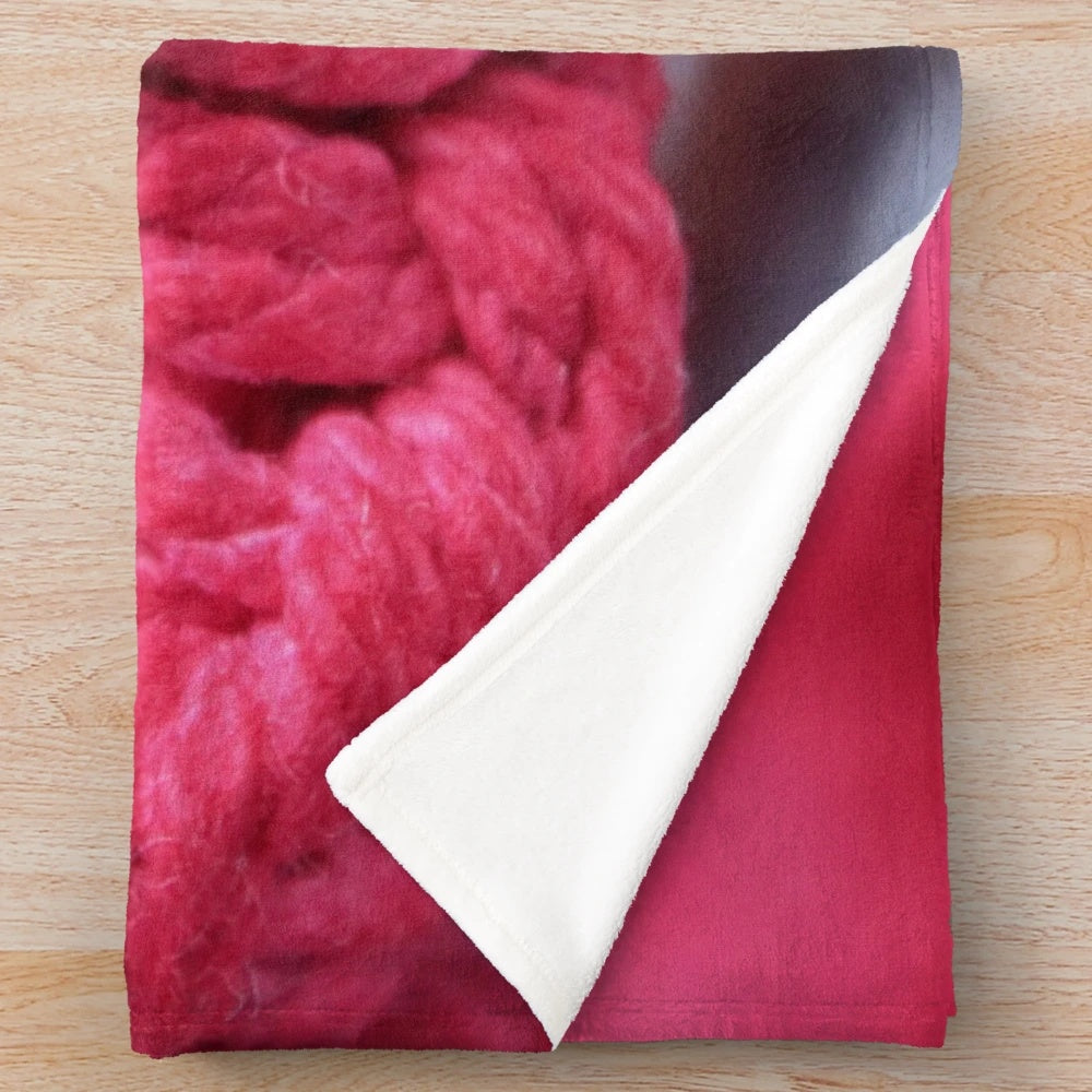 Handmade macrame plush blanket in soft pink and red colors