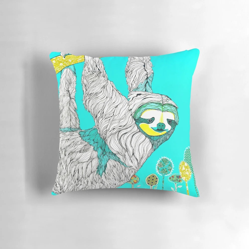 A handmade spring-themed pillow featuring a sloth design in a mixed media collage style with floral elements.