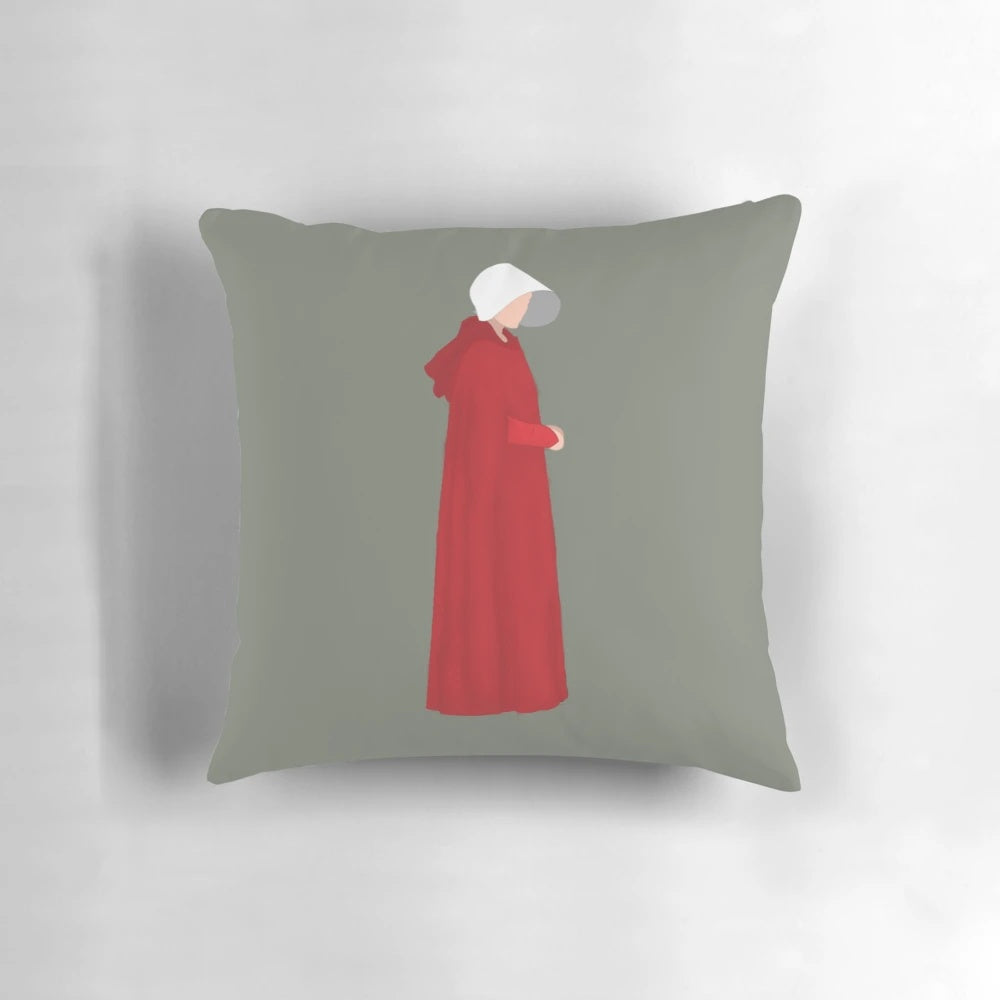 The Handmaid's Tale inspired decorative pillow featuring iconic quotes and imagery from the popular Hulu series.