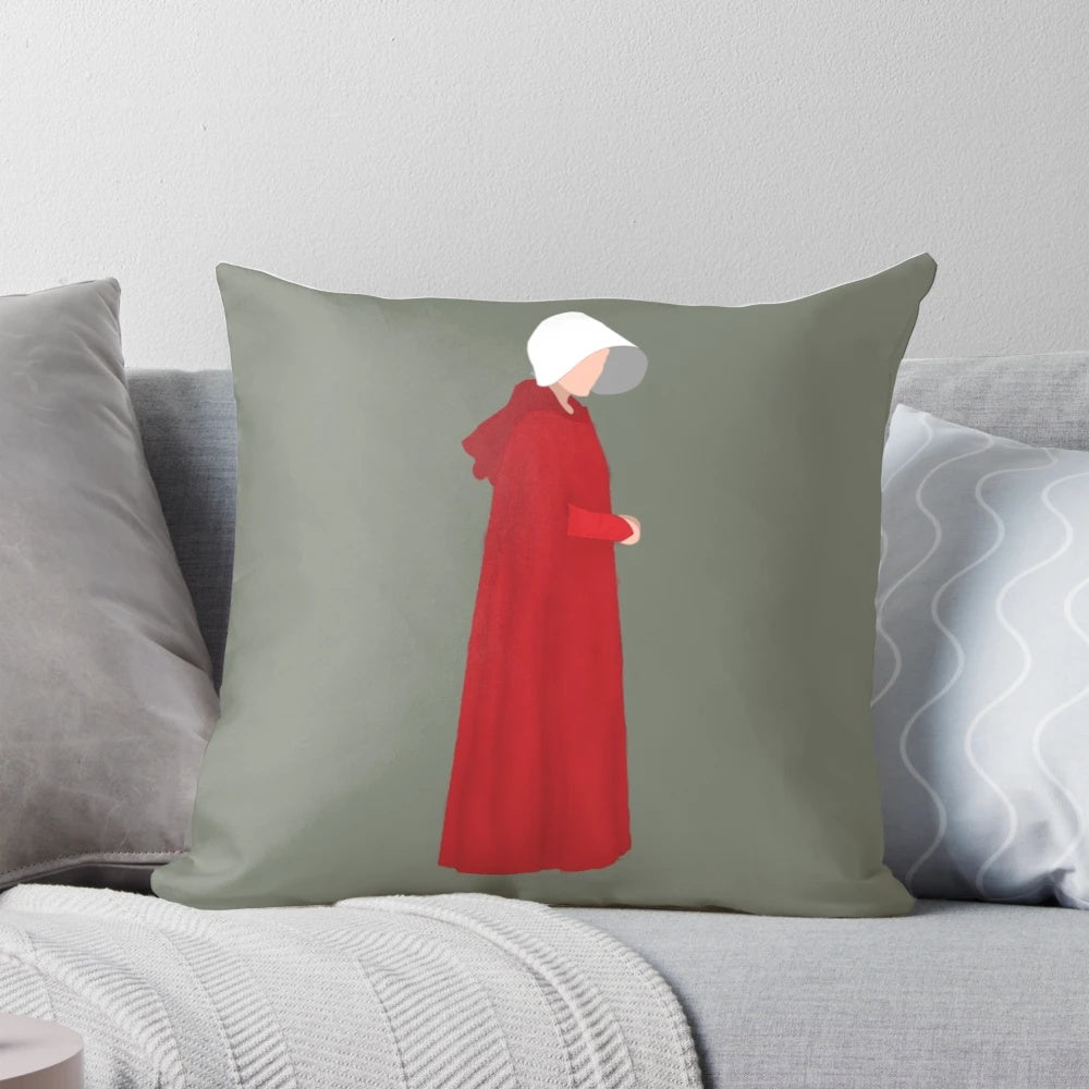The Handmaid's Tale inspired decorative pillow featuring iconic quotes and imagery from the popular Hulu series.