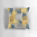Handpainted abstract pattern in shades of mustard yellow, grey, and navy blue on a throw pillow