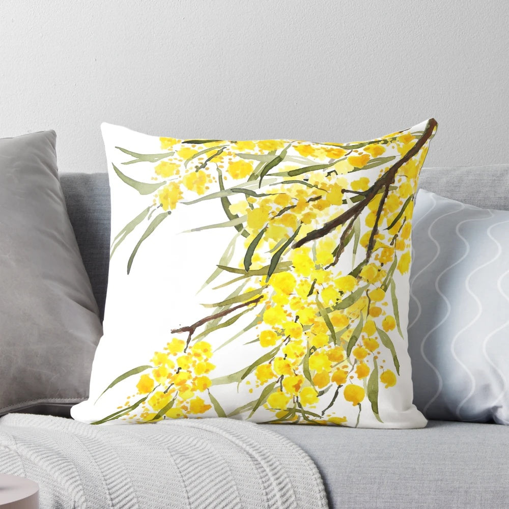 Watercolor painting of a golden wattle flower, a native Australian plant, on a decorative throw pillow.