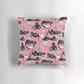 A decorative pillow featuring a hand-painted pattern of black cats on a strawberry pink background.