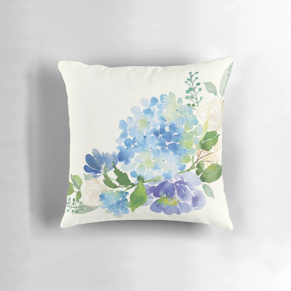 A beautiful blue watercolor hydrangea floral design on a decorative throw pillow.