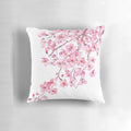 Handpainted pink cherry blossom watercolor design on a decorative throw pillow