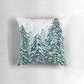 Handpainted green and white pillow with a snowy pine forest landscape design