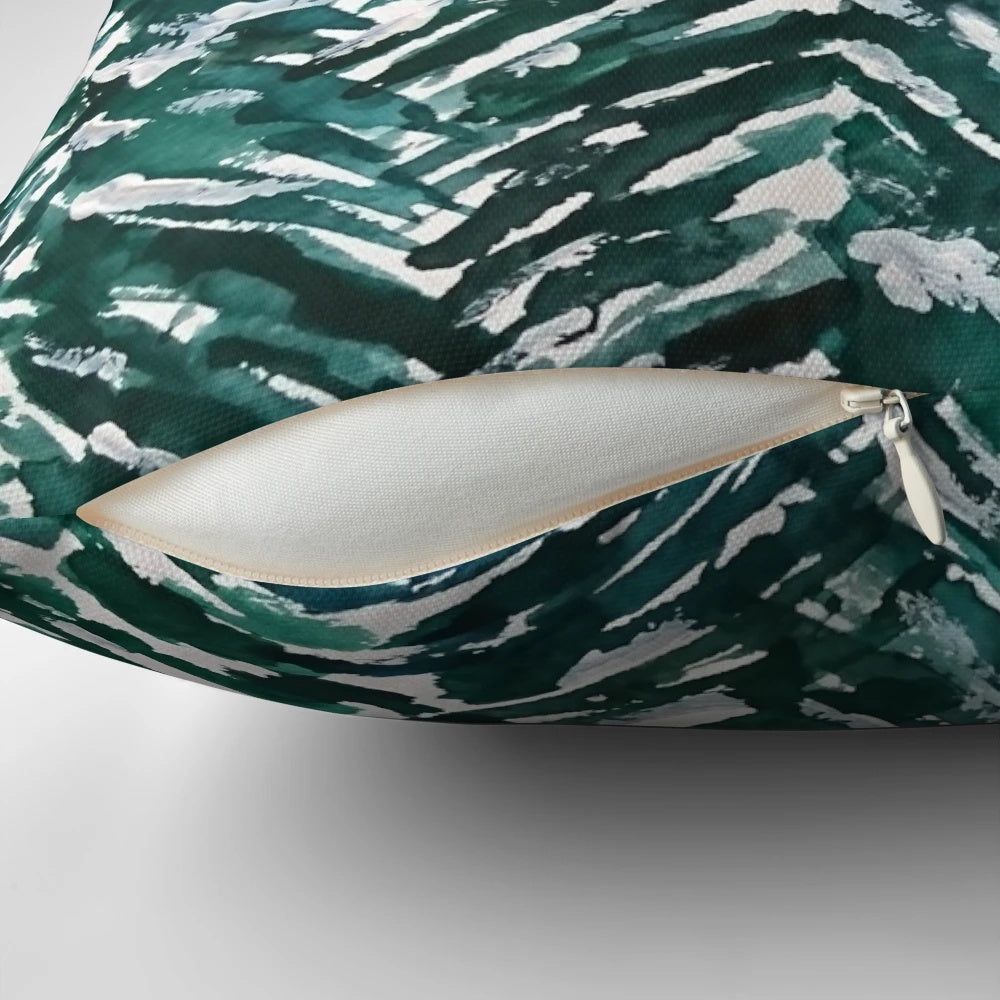 Handpainted green and white pillow with a snowy pine forest landscape design