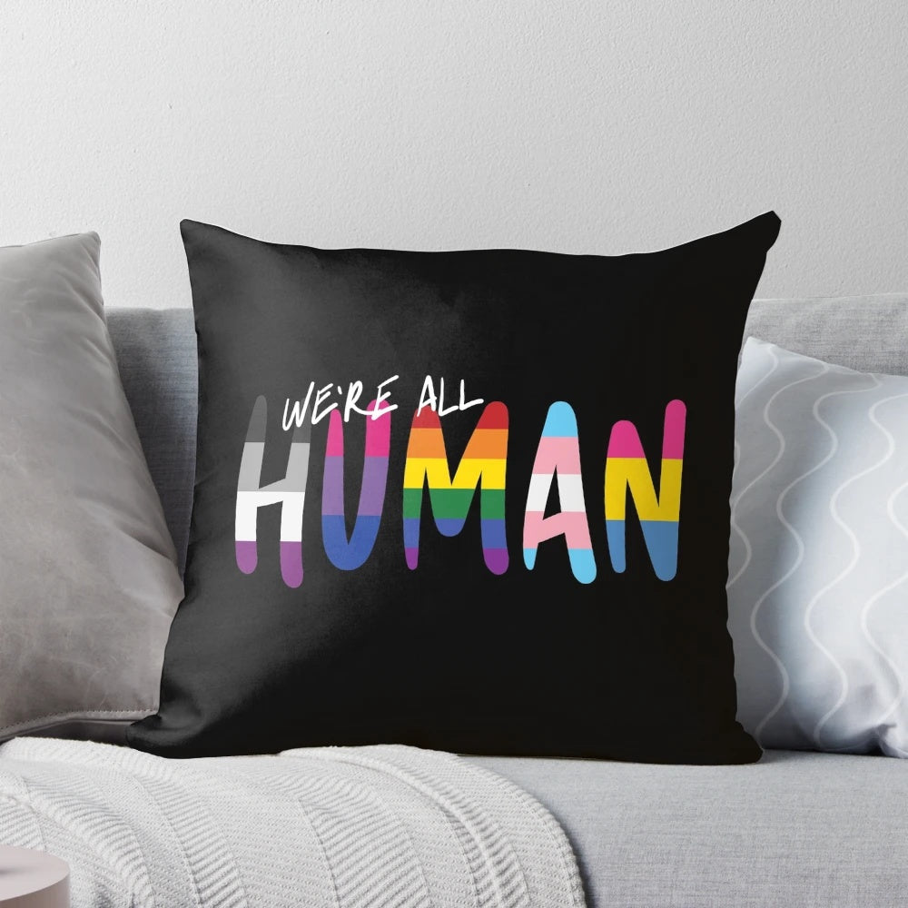 Colorful handwritten pride flags in stripes on a soft pillow, showcasing LGBTQIA+ identity and inclusivity.