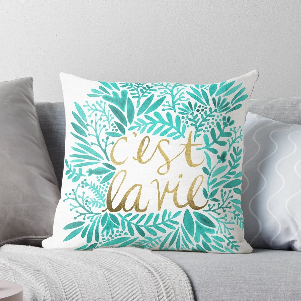 Turquoise and gold throw pillow with handwritten "That's Life" quote and floral design