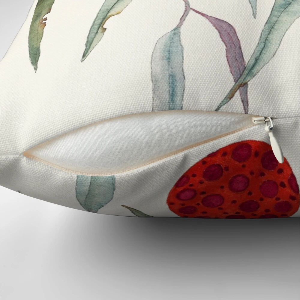 A colorful, water color style Christmas pillow featuring a wombat hanging in a gum tree with festive bobbles.
