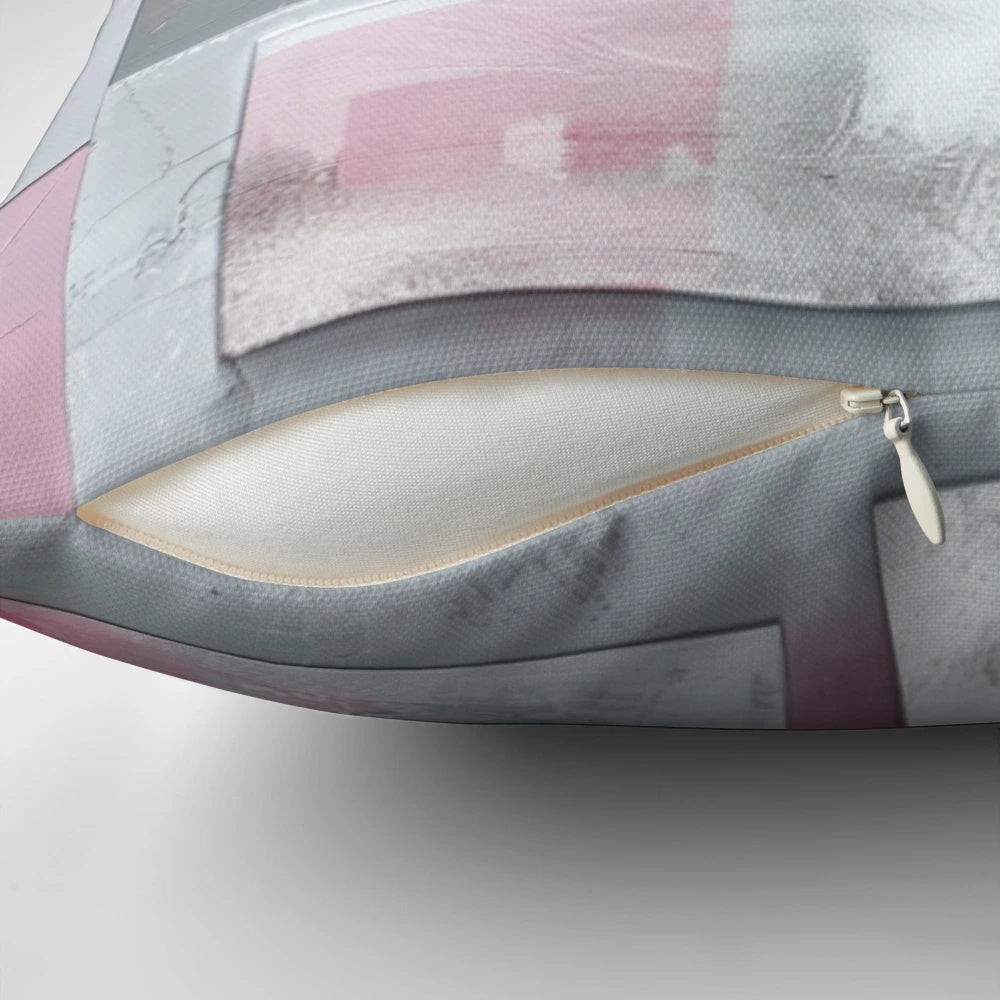 Soft, modern pillow in a harmonious geometric pattern featuring shades of gray and pink.