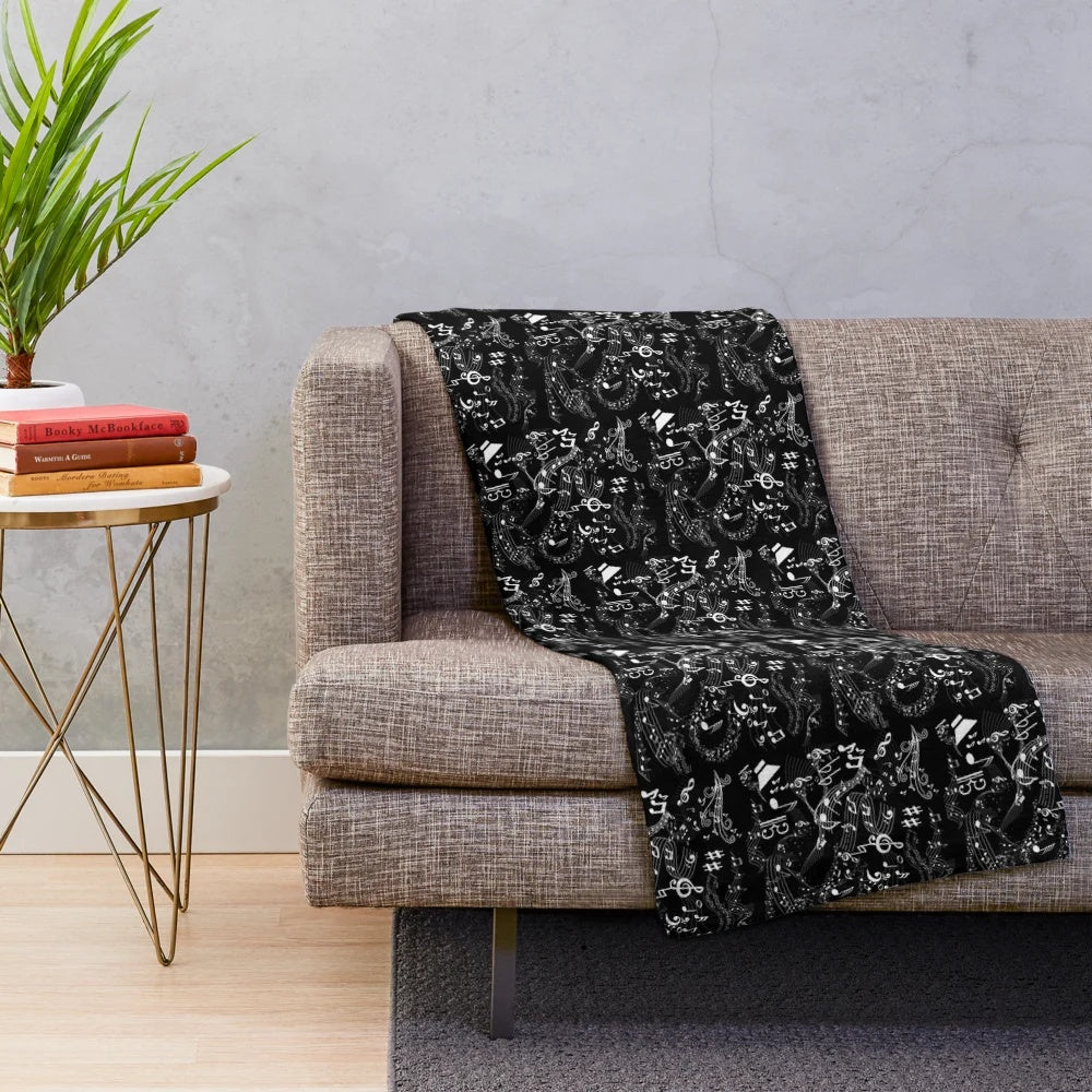 Plush blanket featuring a graphic art design of musical notation elements including treble clef, bass clef, and musical notes