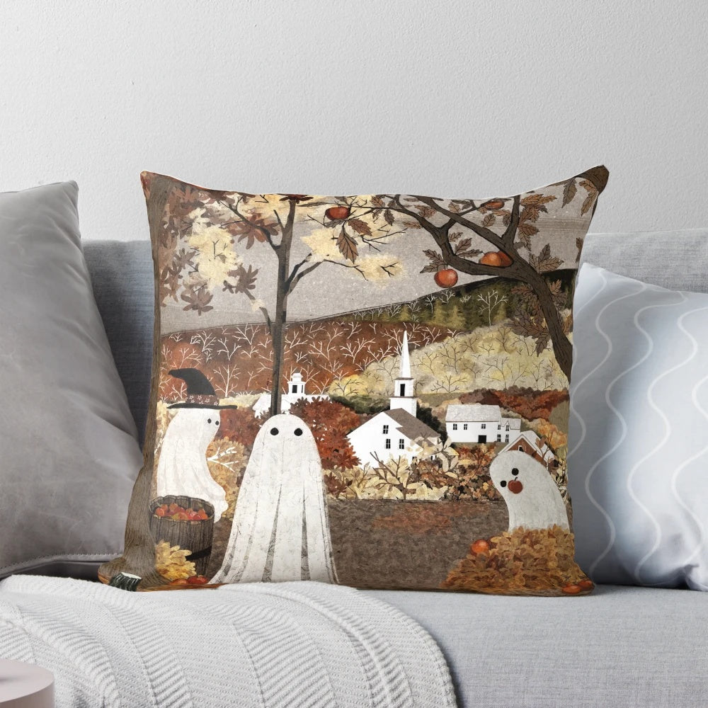 A cozy, autumn-themed pillow featuring a haunted orchard landscape with ghost, pumpkins, and falling leaves.