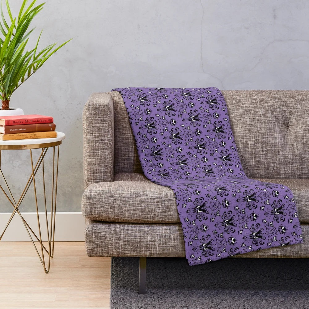 Haunted-inspired plush blanket with ghost and creepy decor elements