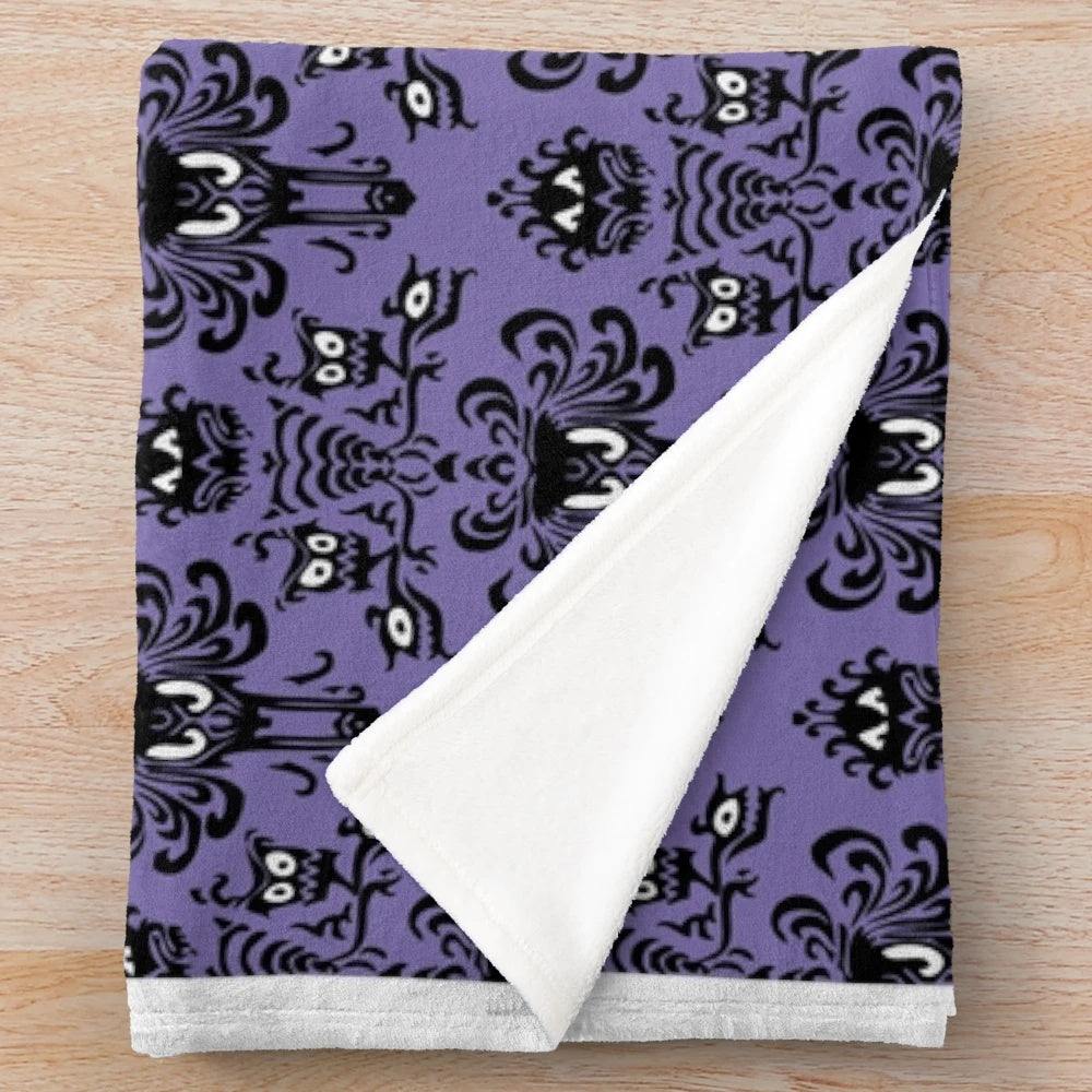 Haunted Mansion inspired plush blanket with Grim Grinning Ghosts design