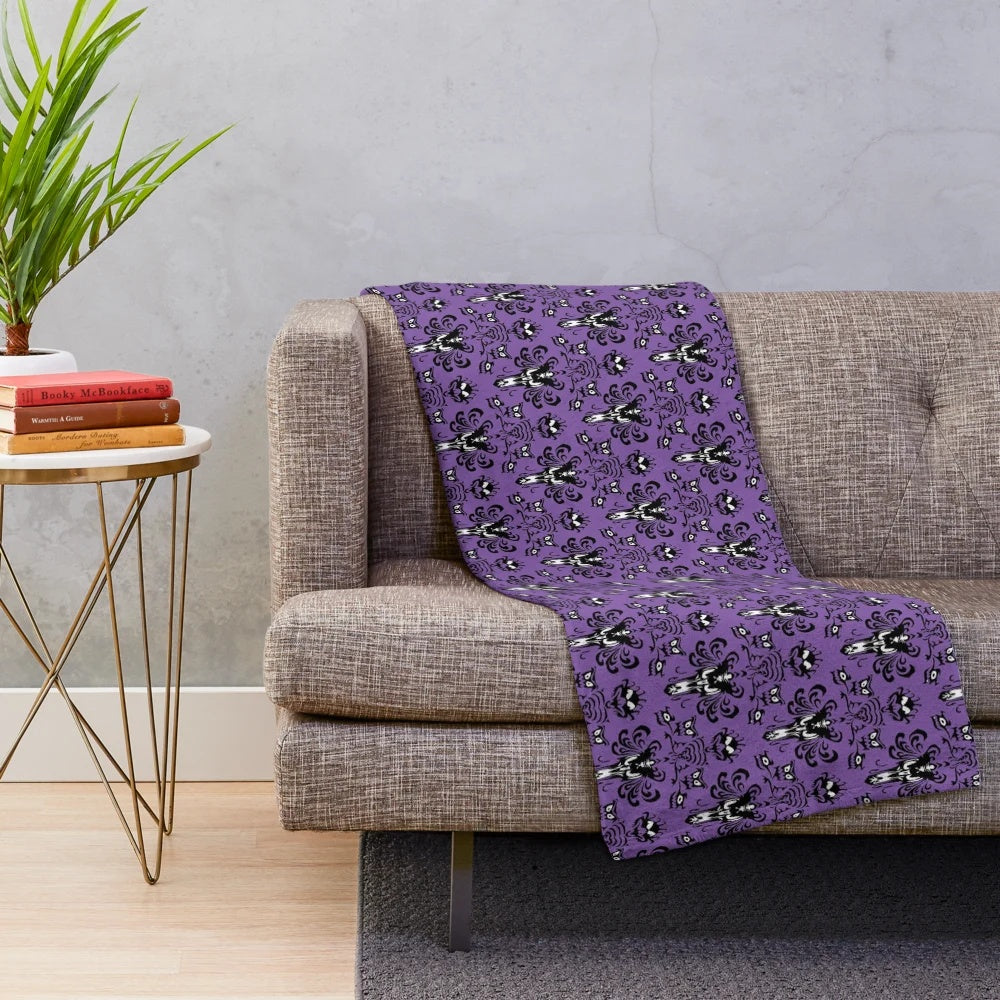Haunted mansion plush blanket featuring gothic inspired wallpaper design
