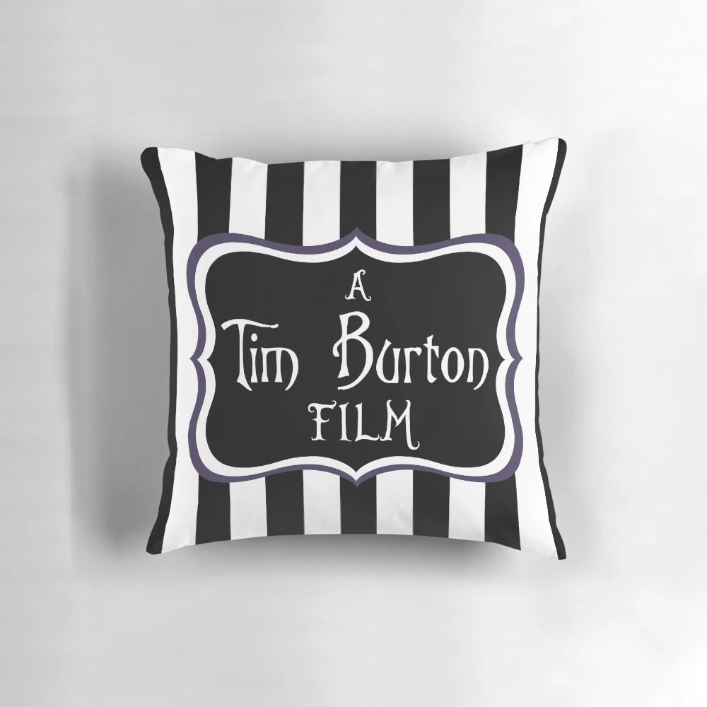 A black and white striped throw pillow with a gothic, eerie vibe, inspired by the films of Tim Burton