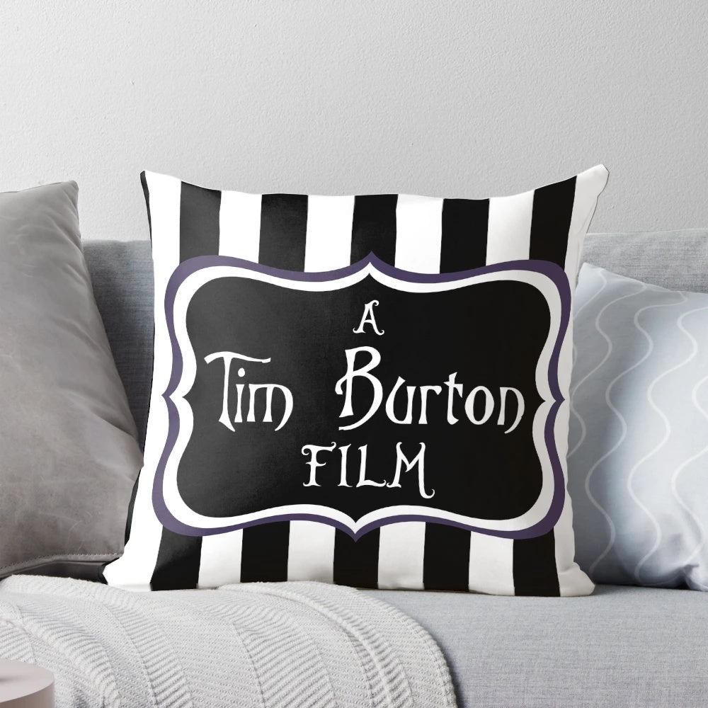 A black and white striped throw pillow with a gothic, eerie vibe, inspired by the films of Tim Burton