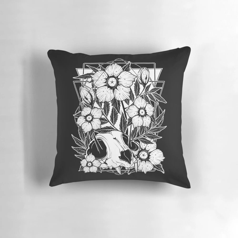 A Pillow featuring a cat skull intertwined with beautiful, dark flowers and botanical elements.