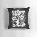 A Pillow featuring a cat skull intertwined with beautiful, dark flowers and botanical elements.