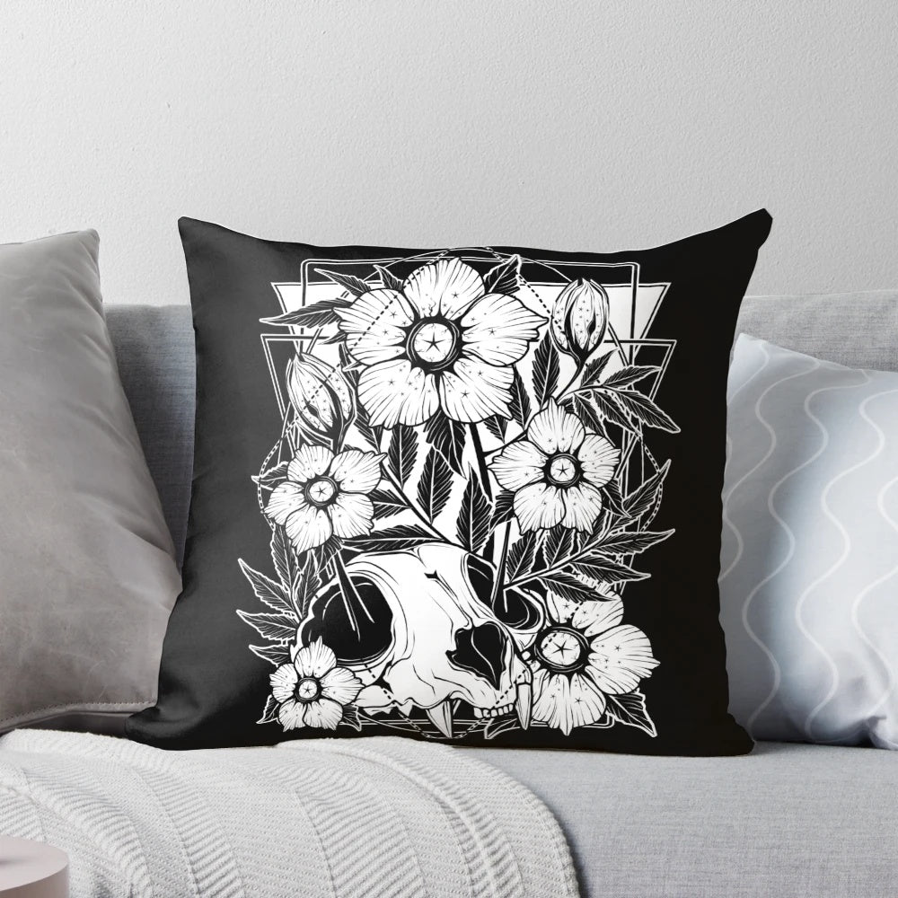 A Pillow featuring a cat skull intertwined with beautiful, dark flowers and botanical elements.
