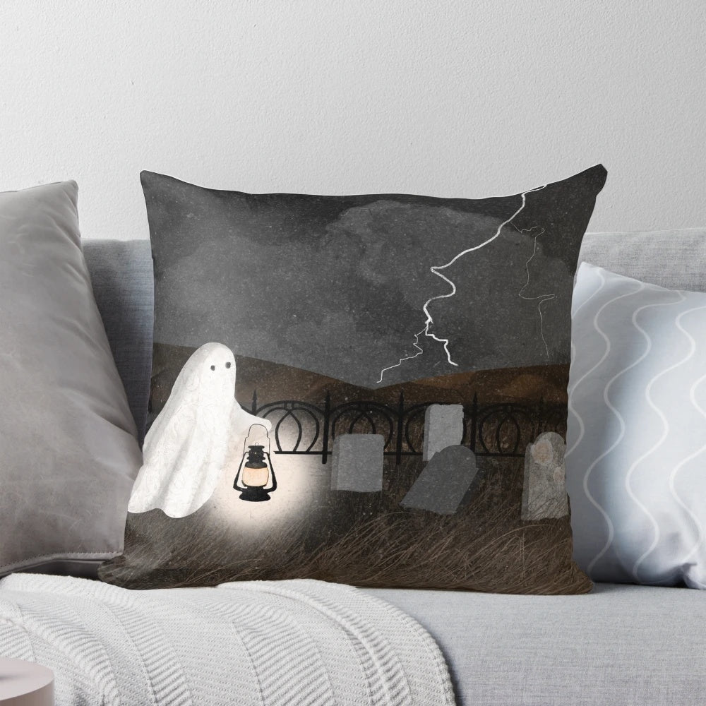 A pillow featuring a haunted graveyard scene with ghostly lanterns, lightning, and gravestones.