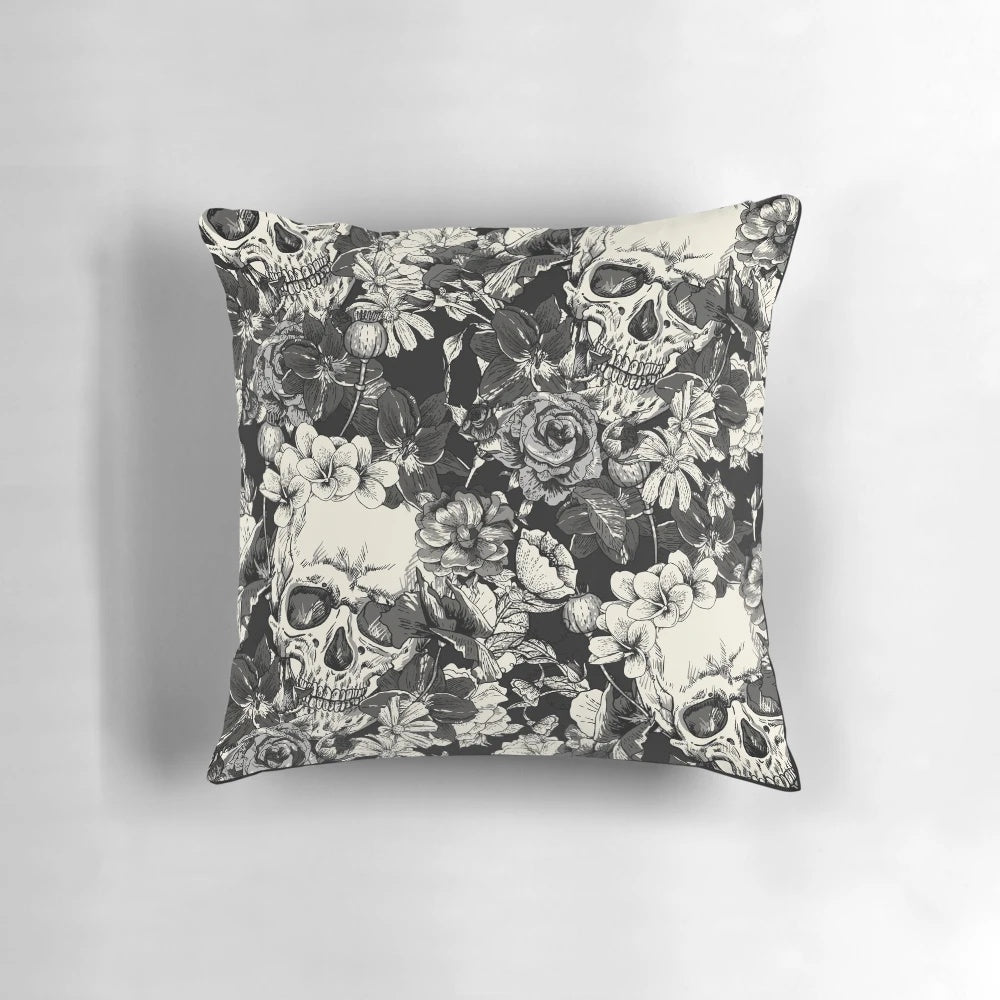 A black and white pillow with a striking skull design, perfect for gothic or Halloween-themed home decor.