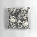 A black and white pillow with a striking skull design, perfect for gothic or Halloween-themed home decor.