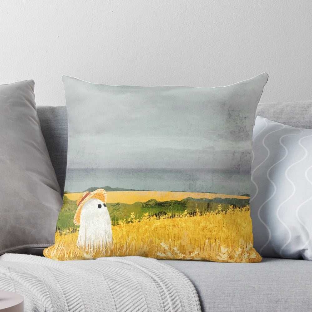 Pillow with a ghostly figure in a picturesque wheat field landscape