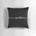 A dark-colored pillow featuring the heartbeat design of a Formula 1 racing car.