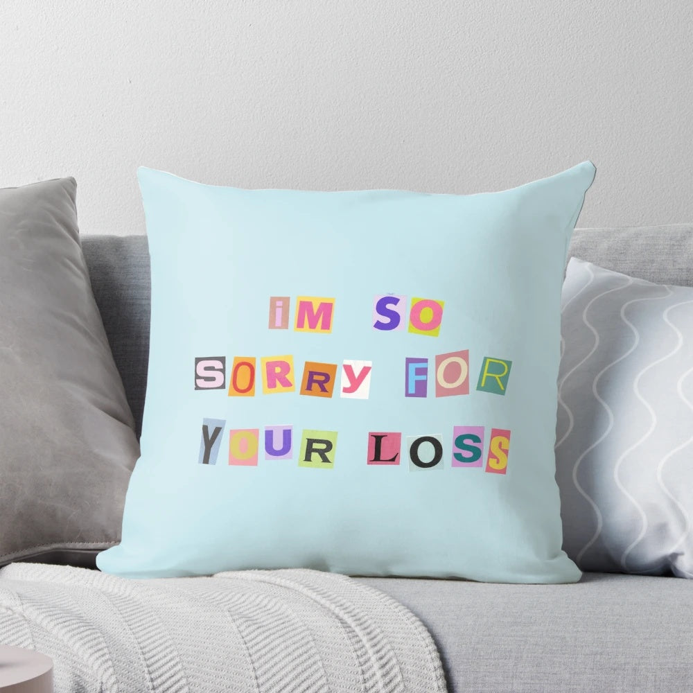 Soft, comforting "I'm So Sorry for Your Loss" pillow featuring a feather design and Sabrina Carpenter's lyrics