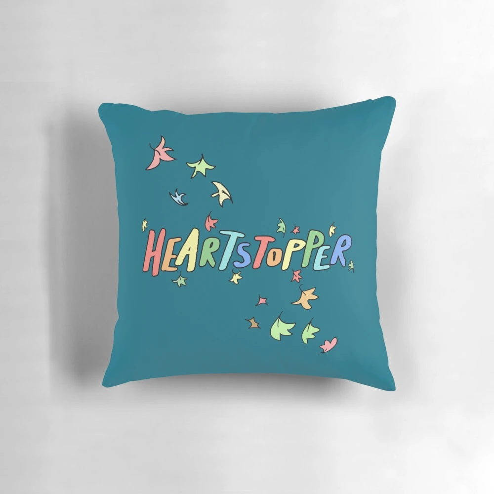 Colorful Heartstopper pillow featuring characters Charlie and Nick in a loving embrace, perfect for LGBTQ home decor
