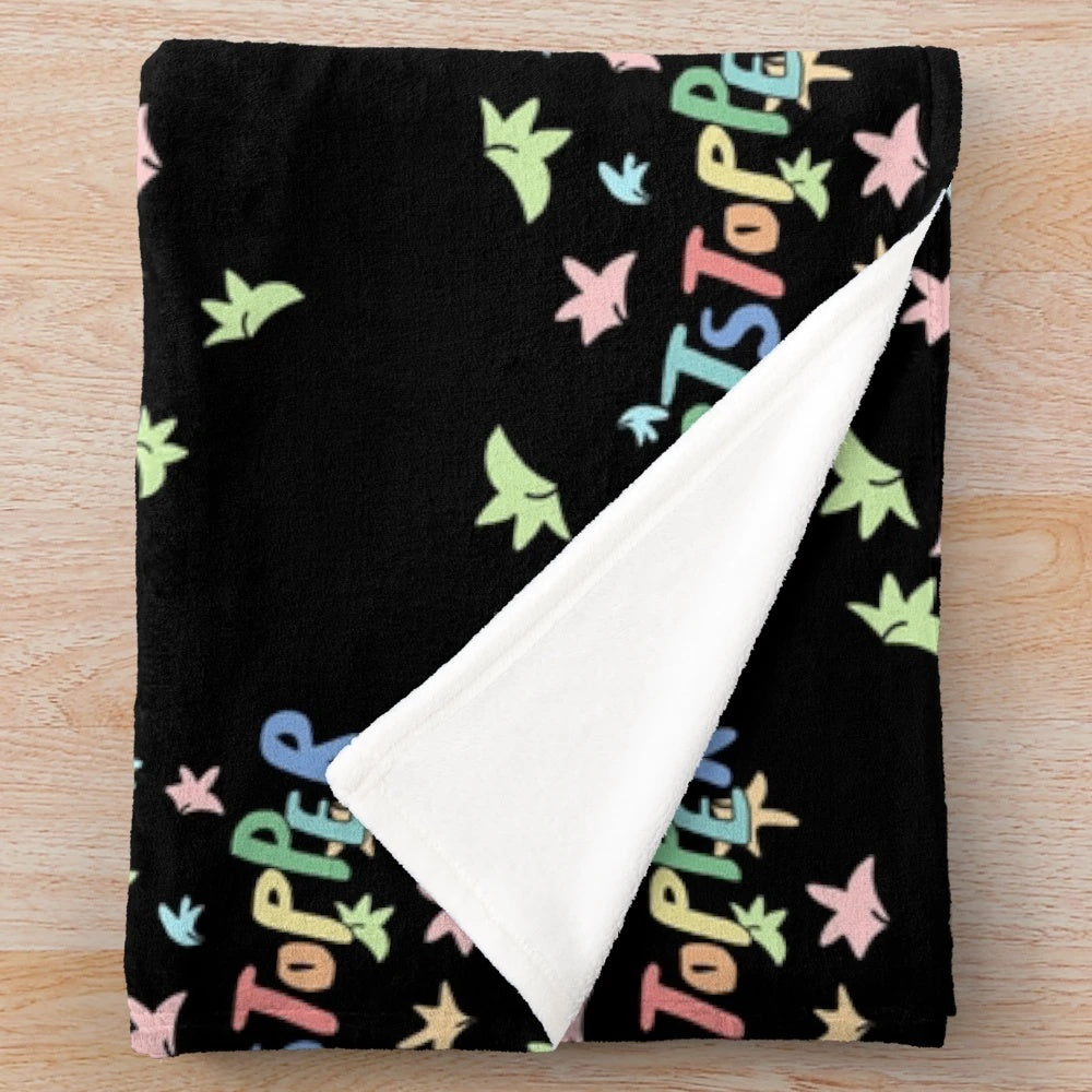 Heartstopper-inspired plush blanket with a black background and a design of leaves
