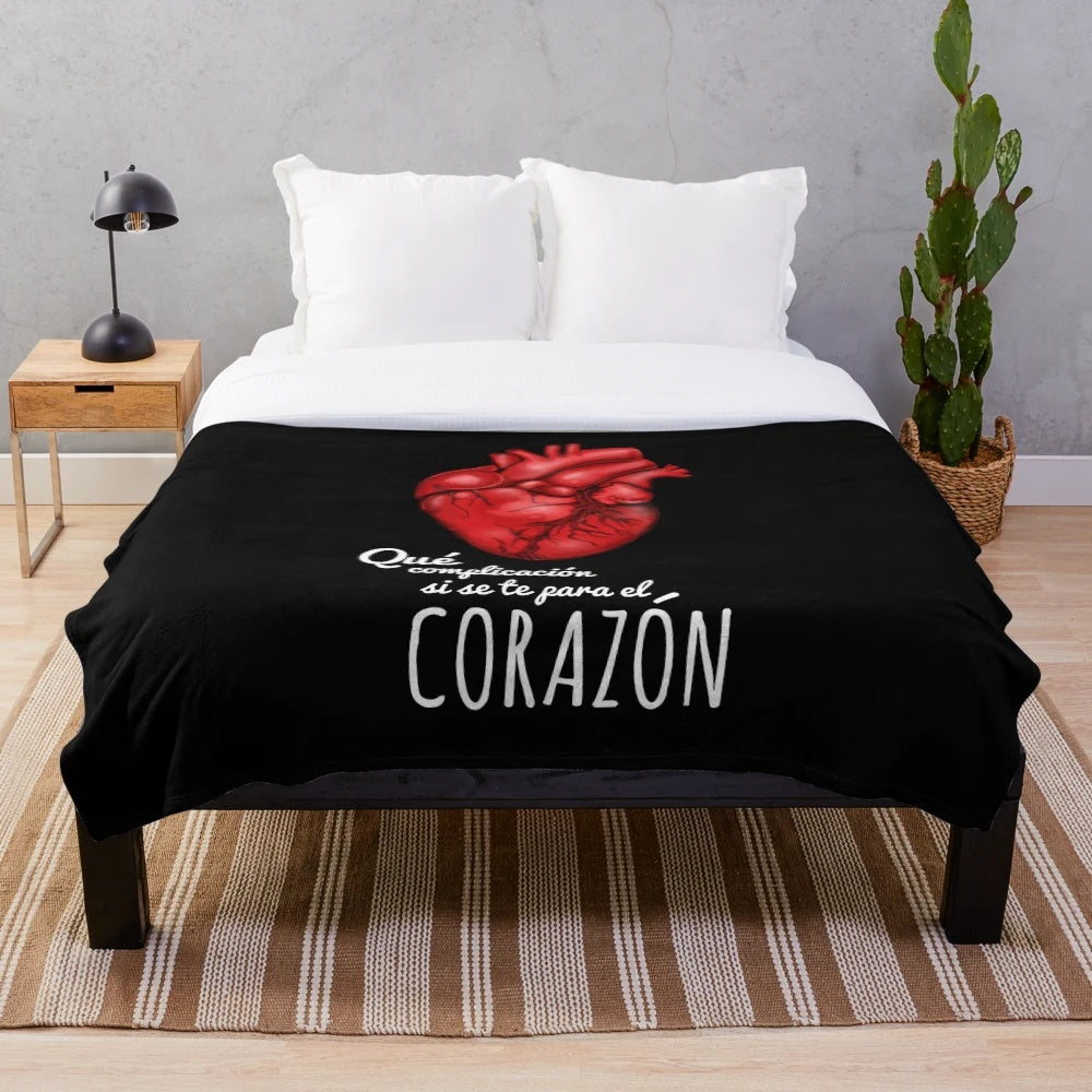 Soft and cozy heart-shaped plush blanket with a sunrise design
