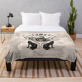 Hecate goddess plush blanket with symbols of the moon, torches, and snakes