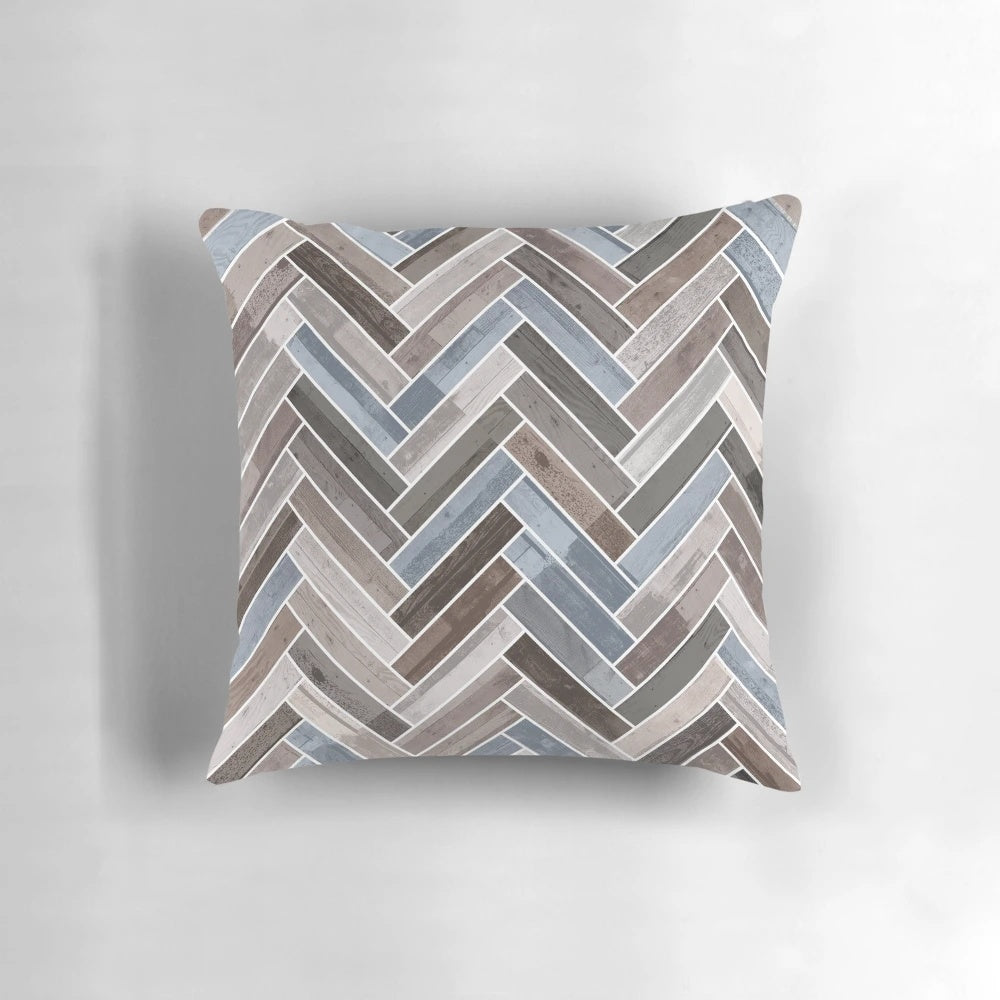 Herringbone pattern neutral color accent pillow in shades of blue, brown, and grey