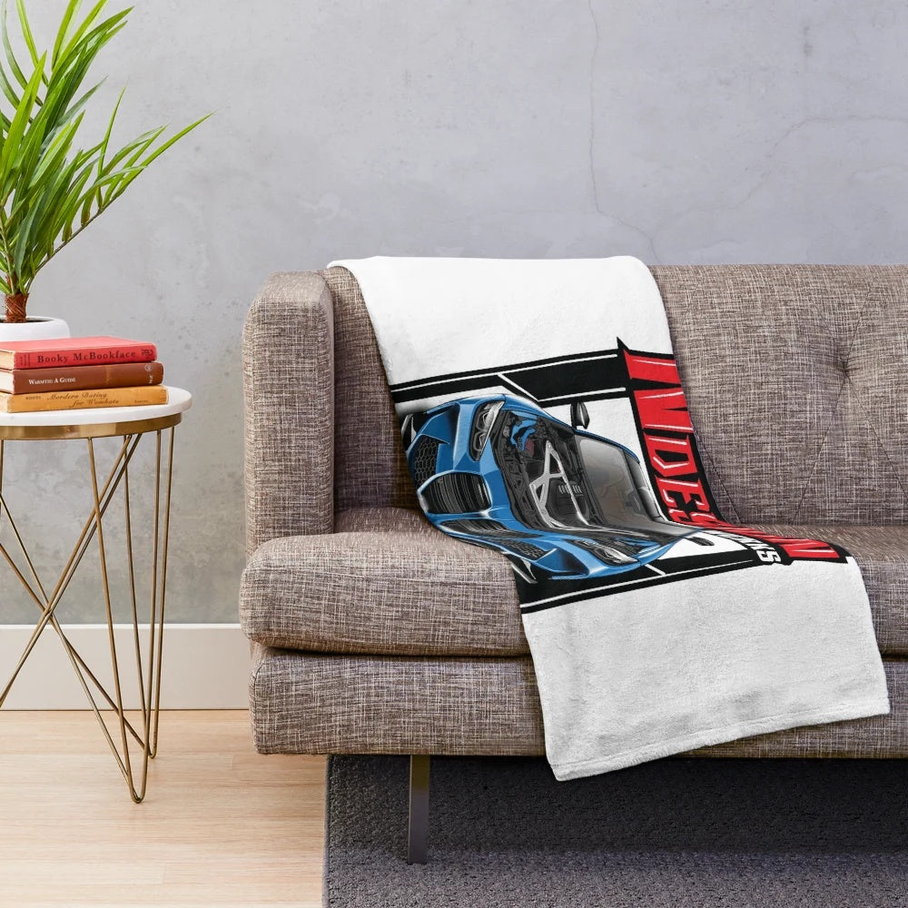 Blue German sports car with open hood on plush blanket