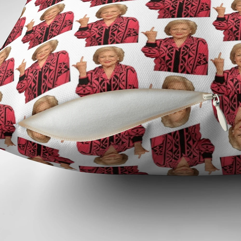 A playful pillow featuring a photo of legendary actress Betty White giving the middle finger, a humorous and sarcastic home decor item.