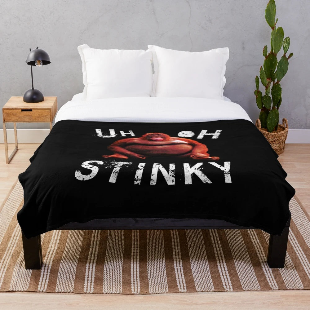 Monke meme-inspired plush blanket featuring humorous "Uh oh, stinky" design