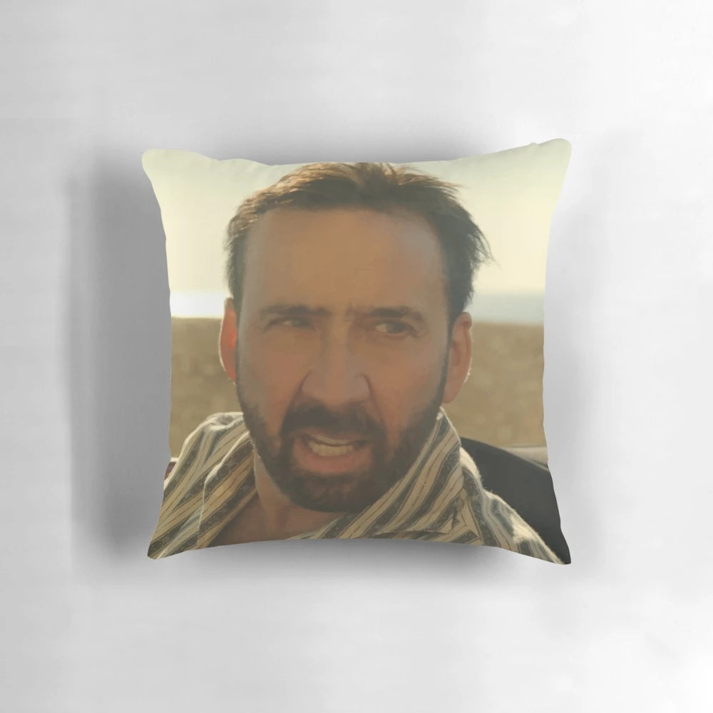 A plush pillow featuring a smiling, meme-worthy image of actor Nicolas Cage.