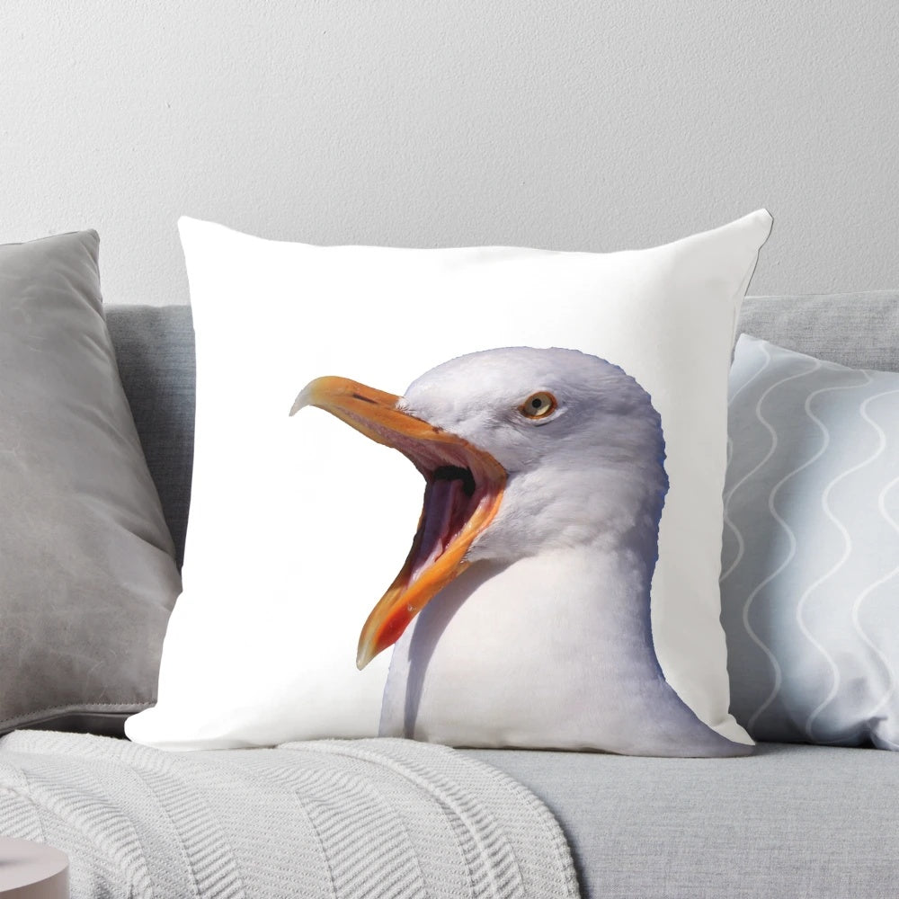 A white and yellow seagull with an open beak screaming on a pillow.