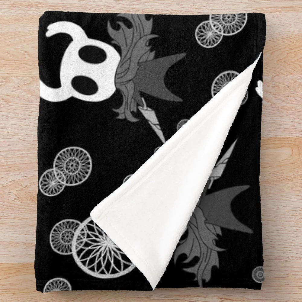 Hollow Knight inspired plush blanket with black and white pattern design