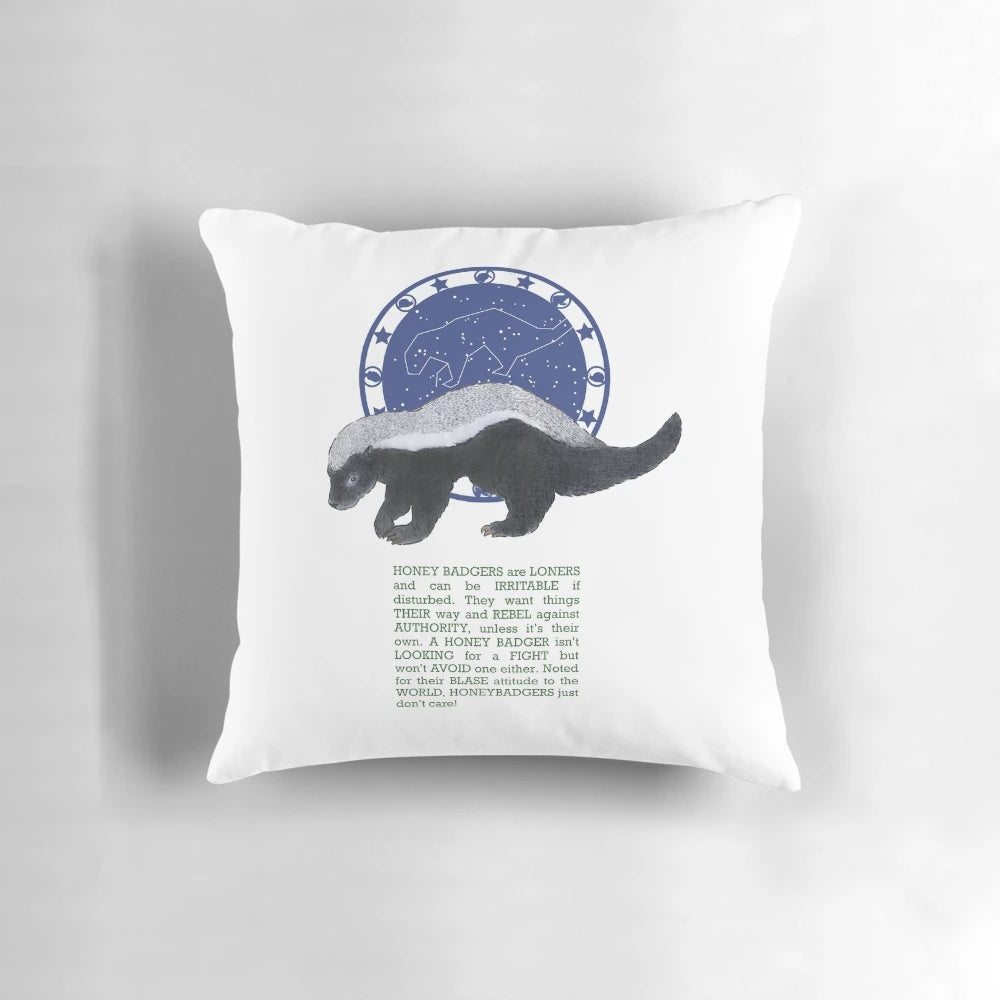 Honey badger illustration on a plush pillow with zodiac stars and symbols